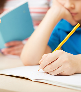 student writing in notebook